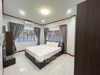 Spacious modern bedroom with elegant decor and natural light