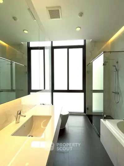 Modern bathroom with sleek fixtures and large window for natural light.