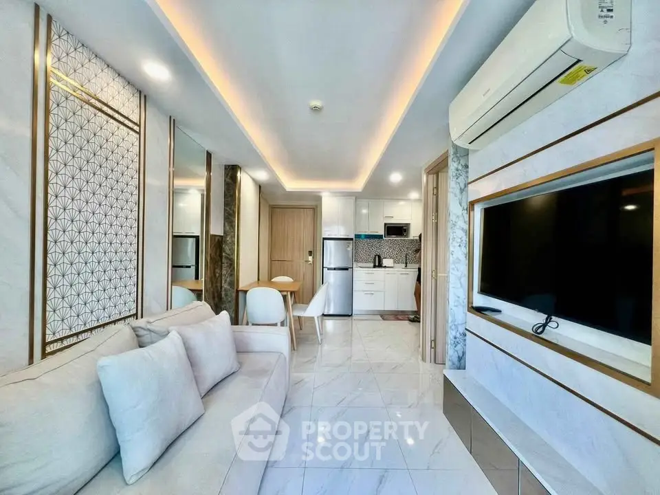 Modern living room with open kitchen, sleek design, and elegant lighting in a stylish apartment.