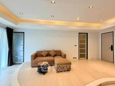 Spacious modern living room with elegant lighting and cozy sectional sofa