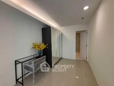 Spacious hallway with modern decor and mirrored wardrobe in a stylish apartment.