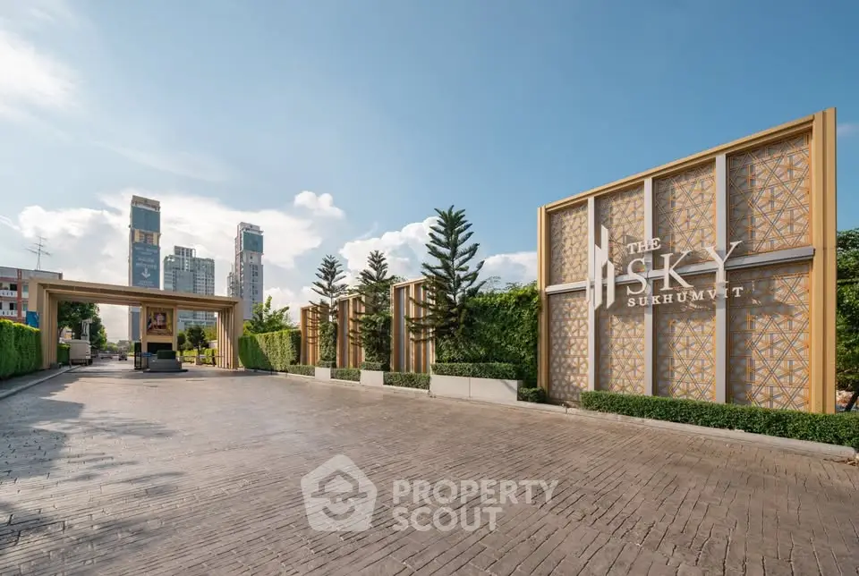 Luxurious entrance of The Sky Sukhumvit with modern architecture and lush greenery.