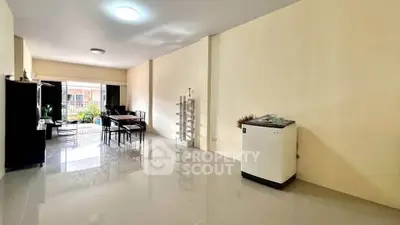 Spacious living room with modern dining area and balcony access