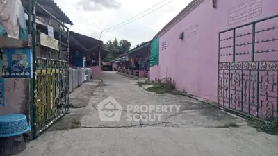 Charming alleyway with colorful walls and rustic gates, perfect for urban exploration.