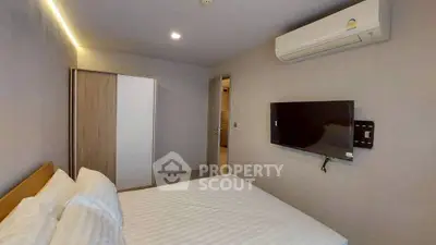 Modern bedroom with air conditioning and wall-mounted TV