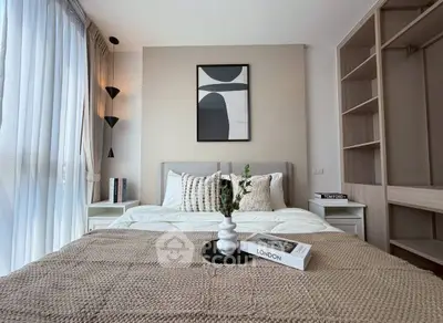 Modern bedroom with stylish decor and natural light, featuring cozy bedding and elegant wall art.