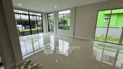 Spacious modern living room with large windows and garden view