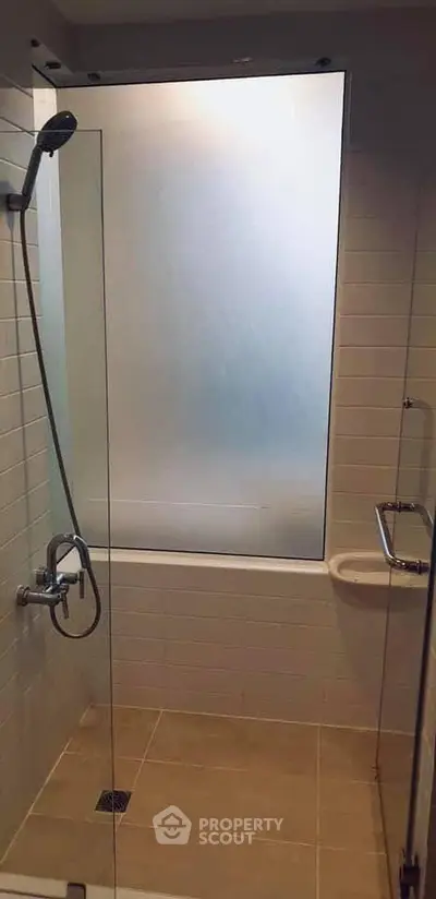 Modern bathroom with frosted glass shower and sleek fixtures