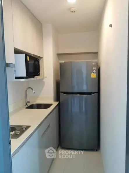 Compact modern kitchen with sleek appliances and efficient layout