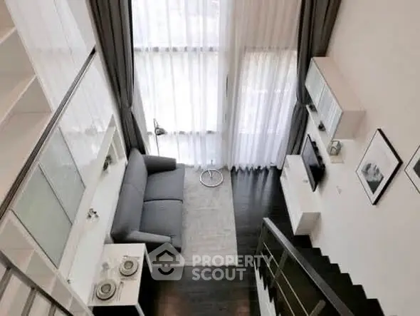 Modern loft-style living room with high ceilings and elegant decor