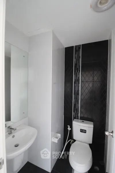 Modern minimalist bathroom with sleek black and white design