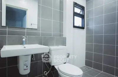 Modern bathroom with sleek gray tiles and white fixtures