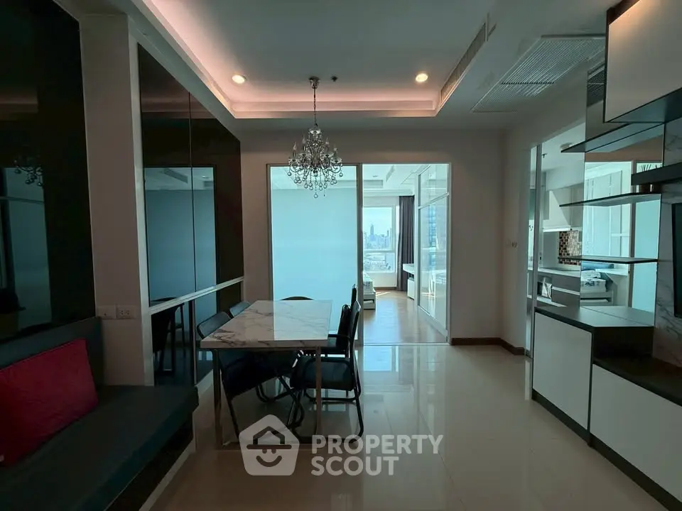 Modern dining area with chandelier and city view in luxury apartment