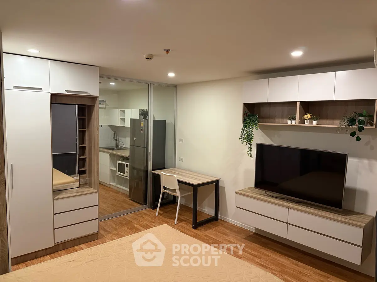 Modern studio apartment with sleek furniture and open kitchen layout