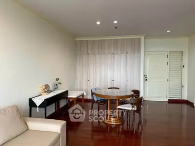 Spacious living room with elegant wooden flooring and modern furniture