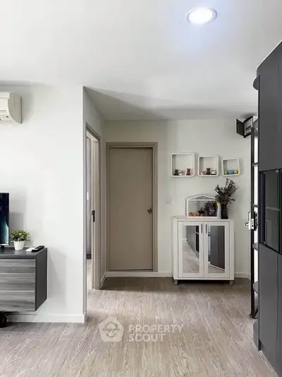 Modern living room with sleek furniture and stylish decor, featuring a minimalist design and neutral color palette.