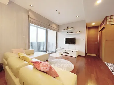 Spacious modern living room with elegant decor and large windows for natural light.
