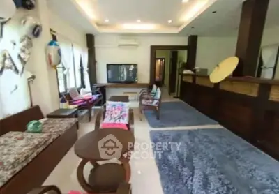 Spacious living room with modern decor and ample natural light