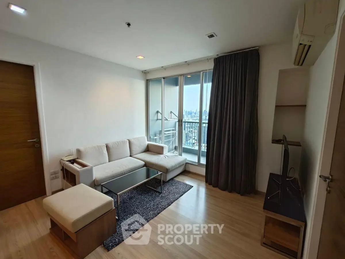 Modern living room with city view, sleek furniture, and natural light.