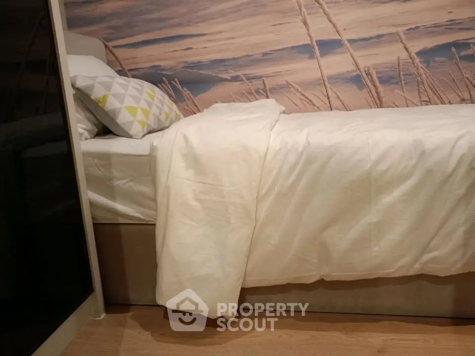 Cozy bedroom with modern decor and stylish wall art, perfect for relaxation and comfort.