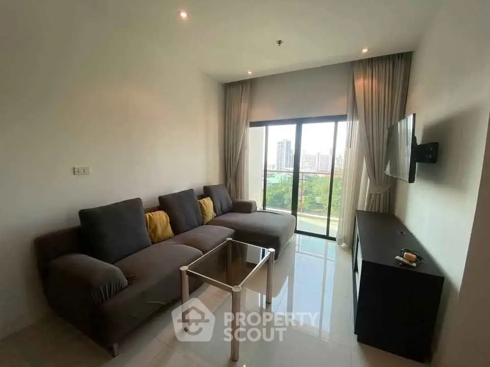 Modern living room with large sofa and city view from window