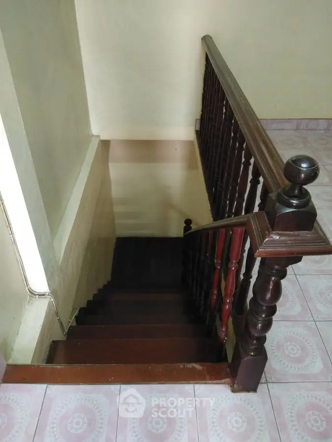 Charming wooden staircase with classic railing in cozy home interior