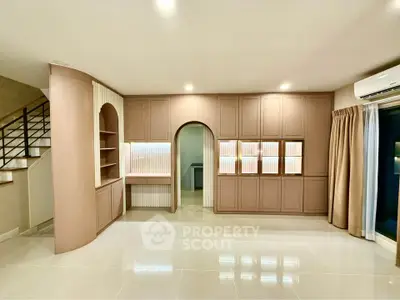 Spacious living room with modern built-in shelves and elegant lighting