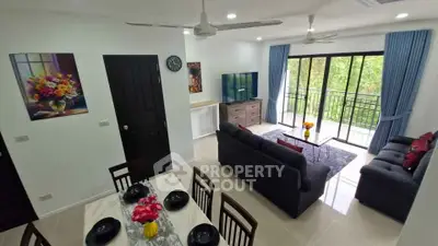Spacious living room with modern decor and balcony view in a stylish apartment.