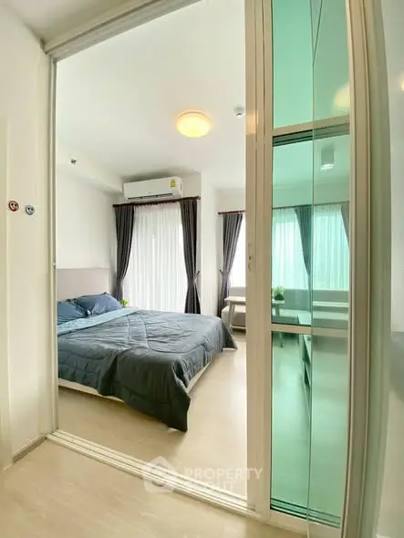 Modern bedroom with sliding glass door and natural light