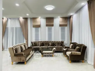Luxurious living room with elegant brown velvet sofas and large windows, perfect for relaxation and entertaining.