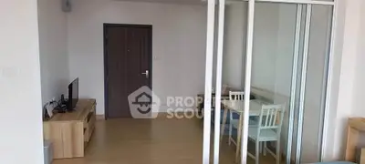 Modern apartment interior with sliding glass doors and wooden flooring