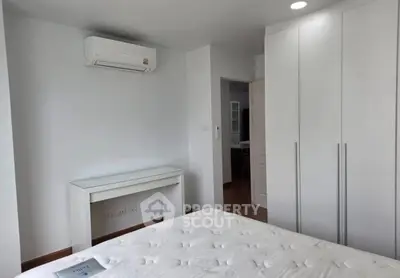 Modern bedroom with air conditioning and sleek white furniture