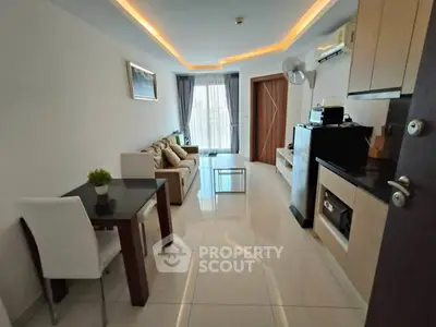 Modern living room with sleek furniture and ambient lighting in a cozy apartment.