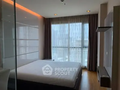 Modern bedroom with large window and city view, featuring sleek design and natural light.