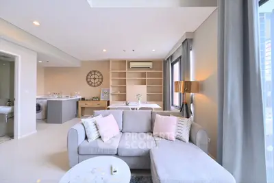 Spacious modern living room with open kitchen and stylish decor in a bright apartment.