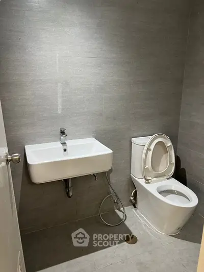 Modern bathroom with sleek gray tiles and contemporary fixtures.