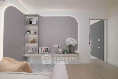 Modern living room with sleek built-in shelves and neutral decor, perfect for contemporary living.