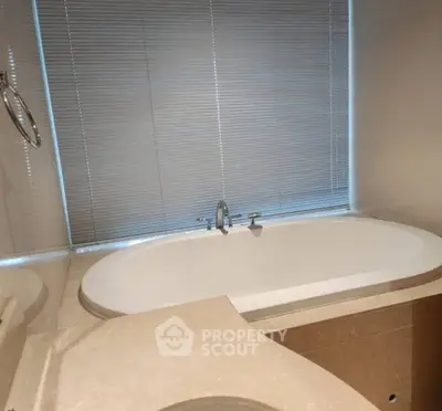 Luxurious bathroom with elegant bathtub and modern fixtures.