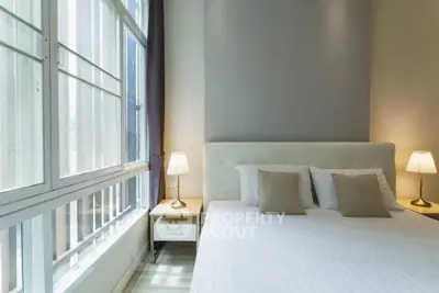 Modern bedroom with large window and stylish decor