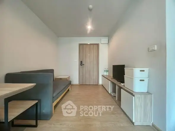 Modern minimalist living room with sleek furniture and wooden flooring