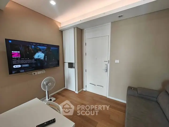 Modern living room with wall-mounted TV and cozy seating area