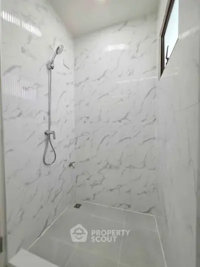 Modern bathroom with elegant marble tiles and sleek shower design