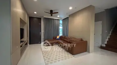 Spacious living room with modern decor and cozy leather sofa