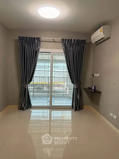 Modern living room with sleek curtains and air conditioning, featuring glossy tiled floors and sliding glass doors.