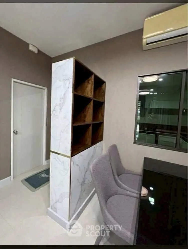 Modern study room with marble accent wall and sleek furniture