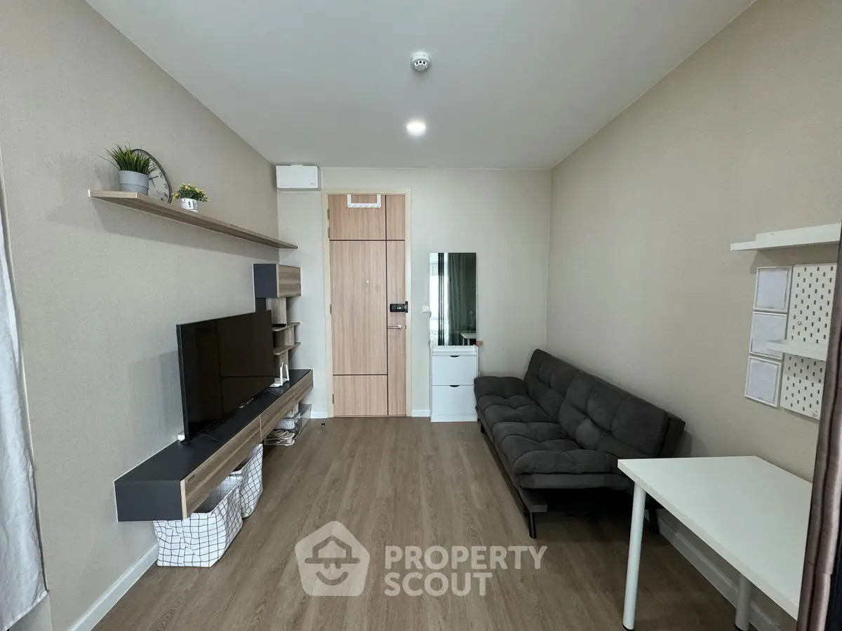Modern living room with sleek furniture and wooden flooring, ideal for cozy gatherings.