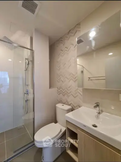 Modern bathroom with glass shower and stylish tile design