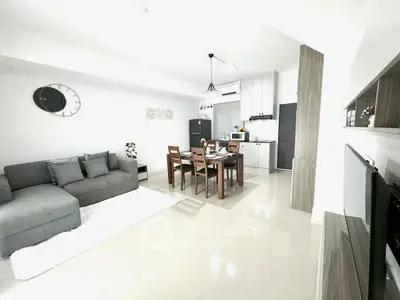 Modern open-layout living room and kitchen with sleek furniture and stylish decor