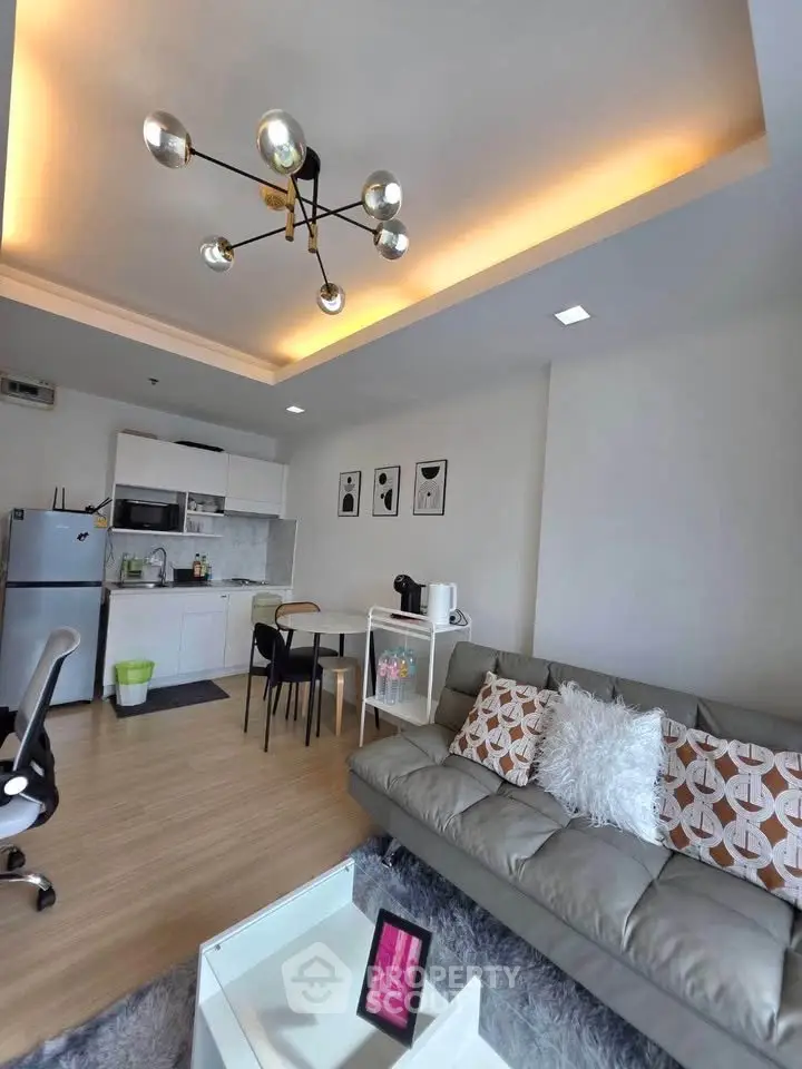 Modern living room with stylish lighting and open kitchen layout