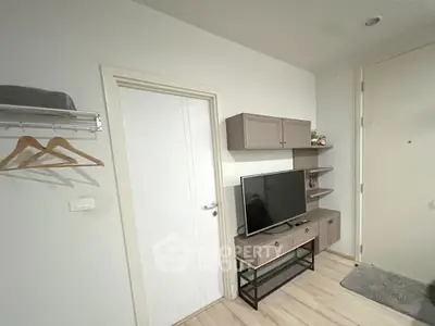 Modern living room with TV stand and wall-mounted cabinets in a cozy apartment.
